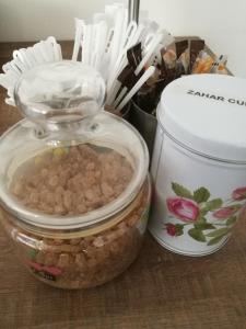 two glass jars with food in them on a table at Casa Altfel in Malaia +25 photos