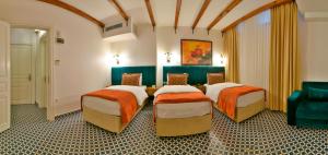 a hotel room with three beds and a couch at Istanbul Life Hotel in Istanbul