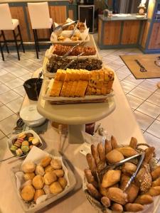 a buffet of different types of food on a table at Hôtel Le Peu Breton in Sainte-Marie-de-Ré