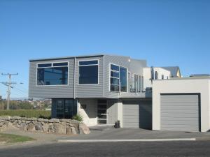a large house with a garage on a street at Pleasant View Bed & Breakfast in Timaru