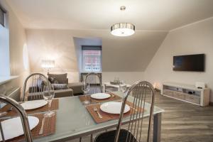 a kitchen and living room with a table and chairs at Old Riga Dome Square Apartment in Riga