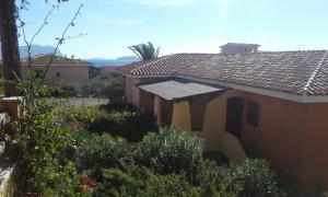 a house with a garden in front of it at Residence Spiaggia Bianca in Golfo Aranci