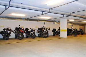 a group of motorcycles parked in a garage at Hotel Crown in Andermatt