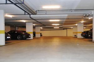a parking garage with cars parked in it at Hotel Crown in Andermatt