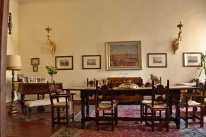 a dining room with a table and chairs at Palazzo Arrivabene B&B in Mantova