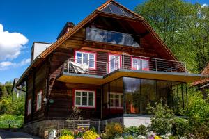 a house with a large window on the side of it at Willa auf der Steinplatte in Teufenbach