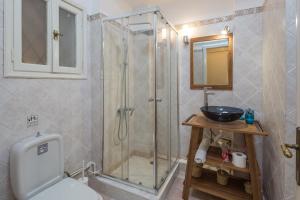 a bathroom with a shower and a toilet and a sink at Elite Downtown Central 5th Floor Apartment in Athens