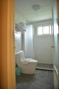 a bathroom with a tub and a toilet and a sink at Royal Yado in Zhixue