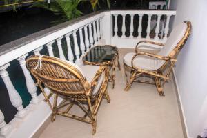 two chairs and a table on a balcony at The Village Resort Palolem in Palolem