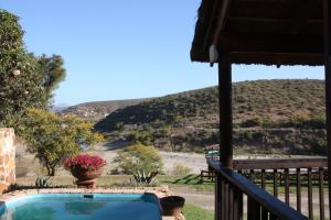 a view from the balcony of a house with a swimming pool at Gourits River Guest Farm in Albertinia