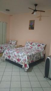 1 dormitorio con 2 camas y ventilador de techo en Home Sweet Home Flats, en Brasilia