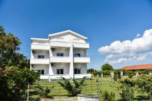 a white apartment building against a blue sky at Sunrise house apartments in Ulcinj