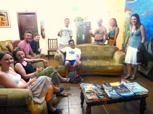 a group of people sitting in a living room at Hostal Terito in Puerto Baquerizo Moreno