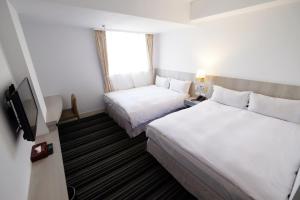 Postel nebo postele na pokoji v ubytování Dynasty Hotel + 37 fotografií