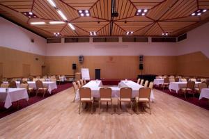 una sala per banchetti con tavoli e sedie bianchi di Hótel Borgarnes a Borgarnes