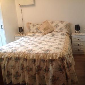a bedroom with a bed and a dresser at Divine Mercy B&B in Knock