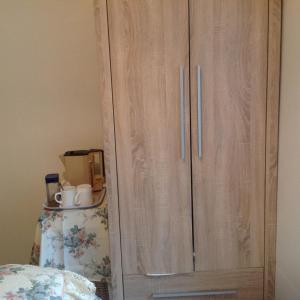 a wooden cabinet with a wooden head board at Divine Mercy B&B in Knock