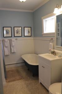 a bathroom with a tub and a sink at Jailer's Inn in Bardstown