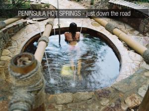 a woman is sitting in a swimming pool in a water tunnel at Silverleaf Cottage in Rye