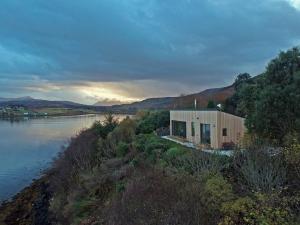 a small house on the side of a river at Air an Oir - Skye Self Catering in Portree