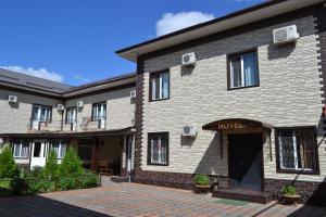 a large brick building with a brick courtyard at Gostinitsa Grand in Qyzylorda