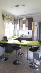 a kitchen with a large counter with stools in it at Palm-Mar 2 rooms Lovely!!! in Arona