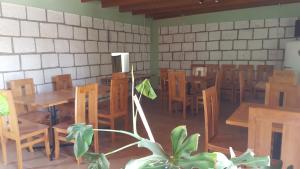 an empty restaurant with wooden tables and chairs at Altos del Lascar in Toconao