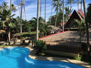 a view of a resort with a swimming pool and palm trees at Pyramid Resort in Panglao Island