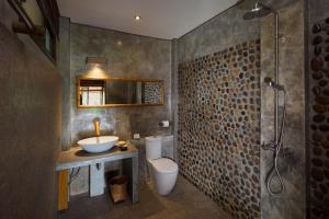 a bathroom with a sink and a toilet and a shower at Bambuh Boutique Homestay in Ban Den +49 photos