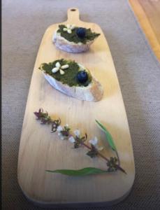 a wooden cutting board with some food on it at Coastline Azure B&B in Donghe