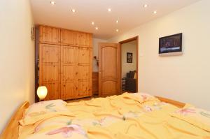 a bedroom with a large bed with flowers on it at Tomsona Apartment Riga Center in Riga