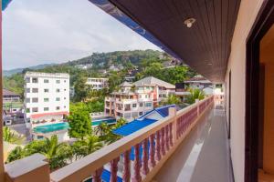 a balcony with a view of a city at Surin Sunset Hotel - SHA in Surin Beach