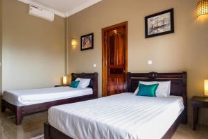 Postel nebo postele na pokoji v ubytování Riviera Hotel & Resort Kep