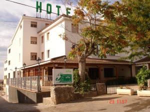 a building with a sign in front of it at La Cañada in Horche