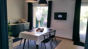 a dining room with a table and chairs and a window at Gites Matilon, 5 min Eugénie les bains in Buanes +23 photos