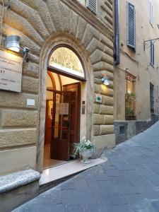 an entrance to a building with a door and a plant at Albergo Tre Donzelle in Siena