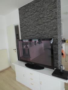 a flat screen tv sitting on top of a white entertainment center at Ferienwohnungen Haus Panorama in Neuschönau