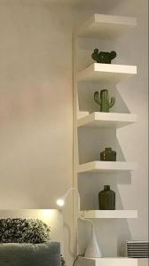 a room with white shelves with cactuses on them at Your suite Ghent in Ghent