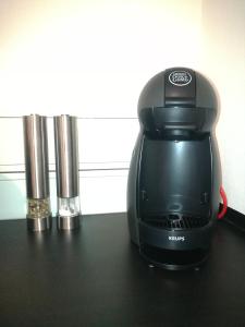 a black coffee maker sitting on a table at Private Apartment Ahlten in Lehrte