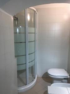 a bathroom with a glass shower and a toilet at Le Grazie Maisons Genova in Genoa +25 photos