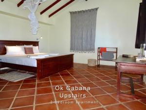 a bedroom with a bed and a desk in it at Ok Cabana Negombo in Negombo