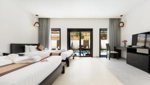 a hotel room with four beds and a desk at Aroma Angkor Boutique Hotel in Siem Reap