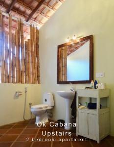 a bathroom with a toilet and a mirror at Ok Cabana Negombo in Negombo