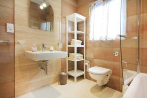 a bathroom with a toilet and a sink and a shower at Mellieha sea and land view apartment in Mellieħa