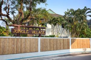 a fence with a sign that reads jungle village at ViLLa JUNGLE 3 BEDROOMS in Kamala Beach