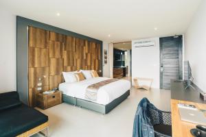 a bedroom with a bed and a desk and a computer at Searocco Phuket in Patong Beach +40 photos