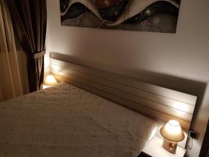 a bedroom with a bed with two lights next to it at Lux Studio 45 in Fortuna in Bansko +26 photos