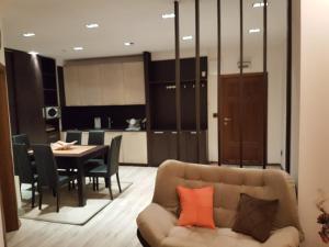 a living room with a couch and a table at Lux Studio 45 in Fortuna in Bansko