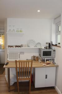 a kitchen with a wooden table and a microwave at Collis Annexe in Didcot