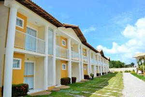 a row of apartment buildings with a pathway at Casa Carmelo #18 in Porto Seguro